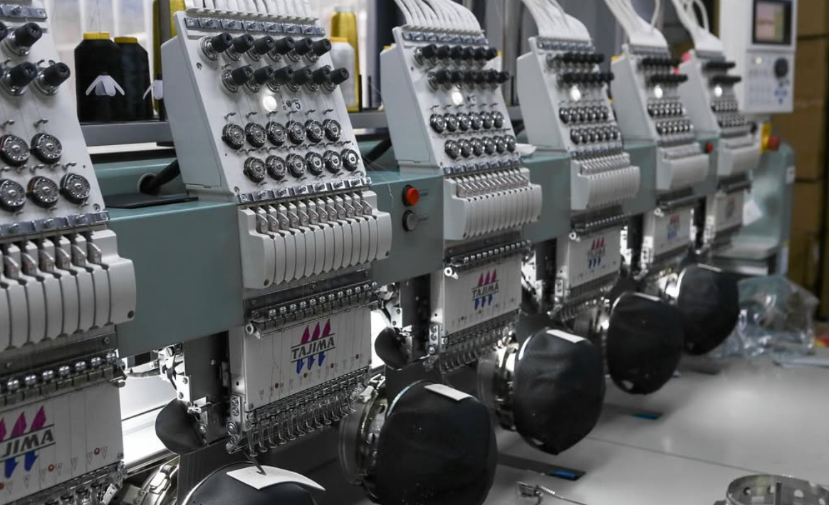 Foremost Headwear modern manufacturing facility showing automated hat production line and skilled workers